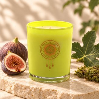 Mahonie Fig & Moss Candle, yellow-green glass, on pale natural stone.