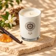 Mahonie Amber and Vanilla Candle, elevated view on pale natural stone.