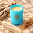 Mahonie Beachwood Vetiver and Driftwood Candle, elevated view on pale natural stone.