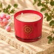 Mahonie Bubblegum Candle, elevated view on pale natural stone.
