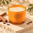Mahonie Cinnamon & Clove Candle, elevated view on pale natural stone.