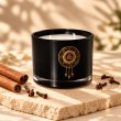 Mahonie Cinnamon & Clove Candle, three-quarter view on pale natural stone.