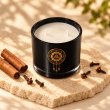 Mahonie Cinnamon & Clove Candle, elevated view on pale natural stone.