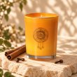 Mahonie Cinnamon Clove Candle, three-quarter view on pale natural stone.