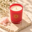 Mahonie Cotton Candy Candle, elevated view on pale natural stone.