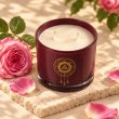 Mahonie Damask Rose Candle, elevated view on pale natural stone.