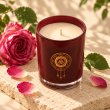Mahonie Damask Rose Candle, elevated view on pale natural stone.