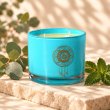 Mahonie Eucalyptus & Mint Candle, three-quarter view on pale natural stone.
