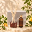 Mahonie L'étoile Reed Diffuser Set - Neroli, original bottle, reeds, refill and box shown on source, on pale natural stone.