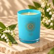 Mahonie Lily of the Valley Candle, three-quarter view on pale natural stone.