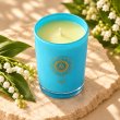 Mahonie Lily of the Valley Candle, elevated view on pale natural stone.