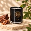 Mahonie Mahogany Scented Candle, three-quarter view on pale natural stone.