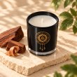 Mahonie Mahogany Scented Candle, elevated view on pale natural stone.