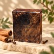 Mahonie Mahonie Exotic Wood Car Freshener - Cinnamon & Clove, original patterned wooden accessory, on pale natural stone.