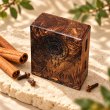 Mahonie Mahonie Exotic Wood Car Freshener - Cinnamon & Clove, elevated view on pale natural stone.
