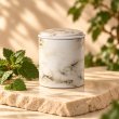 Mahonie Métallique : Exquisite Patchouli Candle, three-quarter view on pale natural stone.