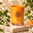 Mahonie Orange Blossom Candle, three-quarter view on pale natural stone.