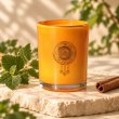 Mahonie Patchouli and Cinnamon Candle, three-quarter view on pale natural stone.