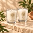 Mahonie Shot Glass Pair : Gilli Mitti Candle, three-quarter view on pale natural stone.