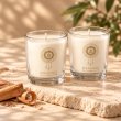 Mahonie Shot Glass Pair : Sandalwood Candle, three-quarter view on pale natural stone.