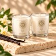 Mahonie Shot Glass Pair : Vanilla Candle, three-quarter view on pale natural stone.