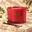 Mahonie Vanilla Candle, red glass, on pale natural stone.
