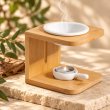 Mahonie Wooden Wax Melt Burner with Candle Holder, bamboo frame with white ceramic bowls, on pale natural stone.