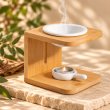 Mahonie Wooden Wax Melt Burner with Candle Holder, three-quarter view on pale natural stone.